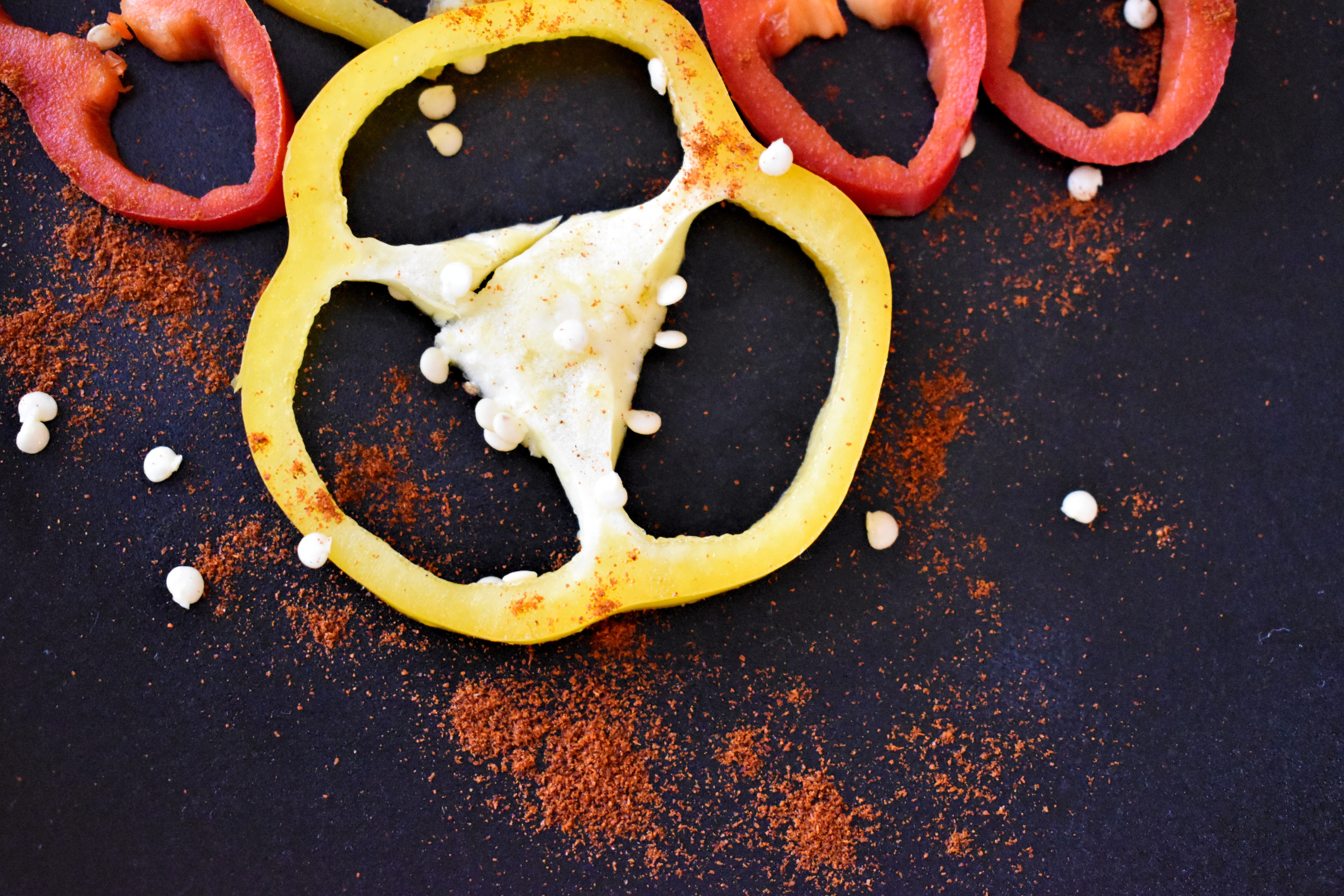 rote und gelbe PAprikascheiben und PAprikapulver aus der Vogelperspektive